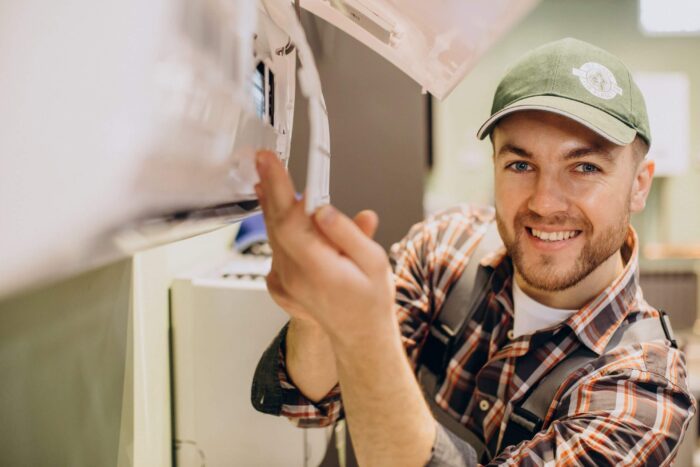 repairman-doing-air-conditioner-servicfe-1 - OrionTechnosoft